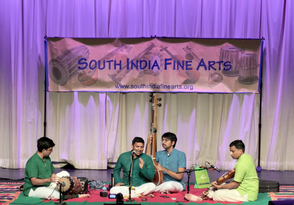 A vocalist performing with violin, mridangam and tambura accompaniment