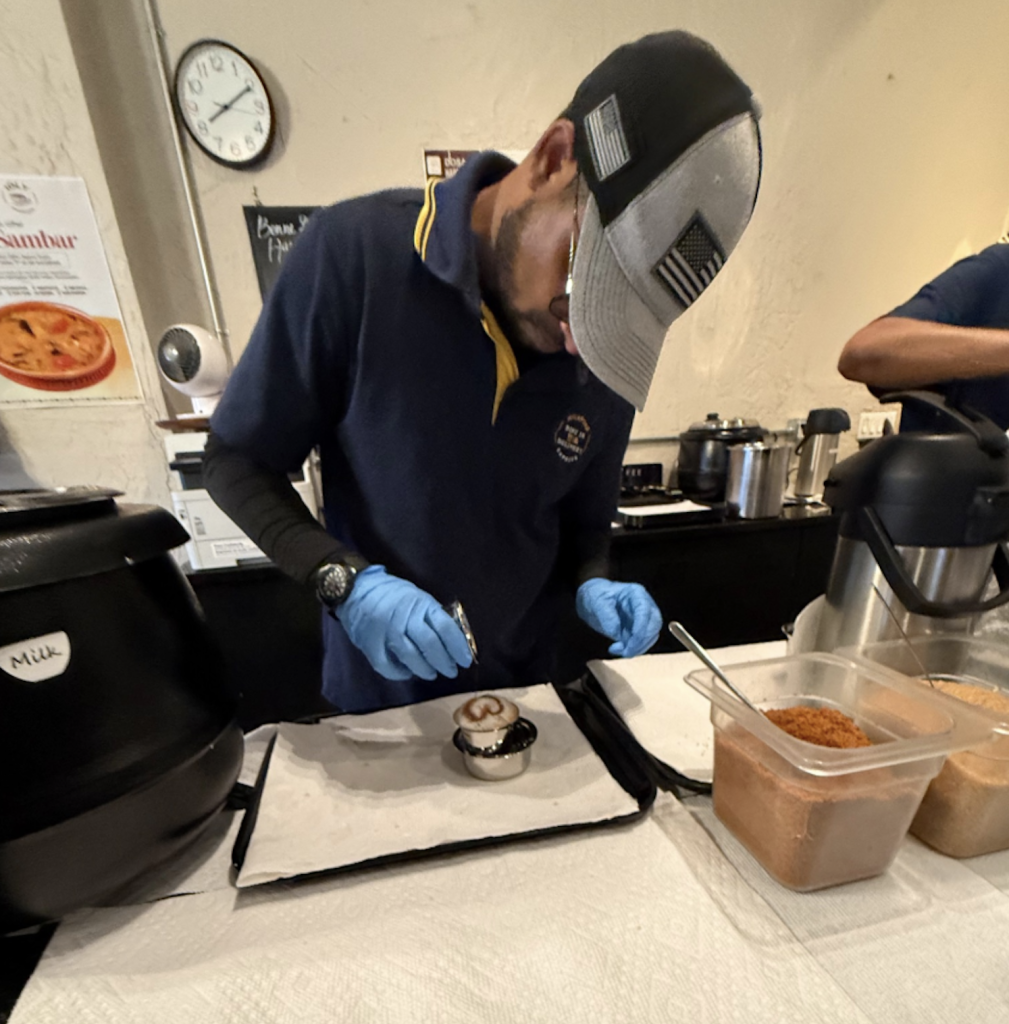 A staff member preparing filter coffee at a counter