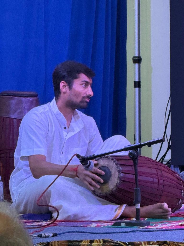 Pranav Tirumalai accompanies the three violinists on the mridangam.